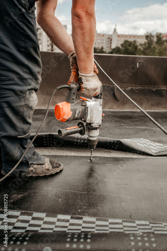 roof repair. a roofer repairs the roof. roofing tools