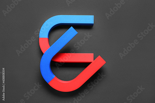 Horseshoe shaped magnets on black background