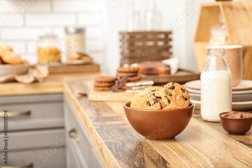 Bowl with cookies on wooden table in kitchen