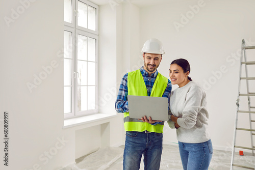 Photography Woman apartment owner discussing home design plan with foreman