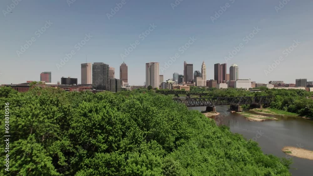 Helicopter aerial and drone establishing shot of Ohio state capital city of Columbus, OH with skyscrapers, skyline, and large buildings and apartments during a warm, summer day in near the Scioto Mile Helicopter aerial and drone establishing shot of Ohio state capital city of Columbus, OH with skyscrapers, skyline, and large buildings and apartments during a warm, summer day in near the Scioto Mile