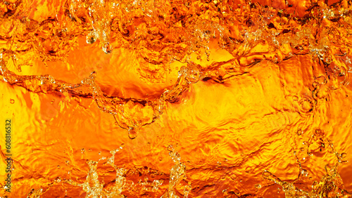 Liquid golden splash texture, abstract beverages background.