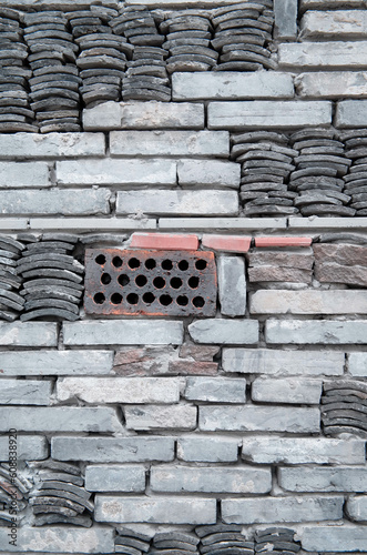 building facade with roof tiles and bricks