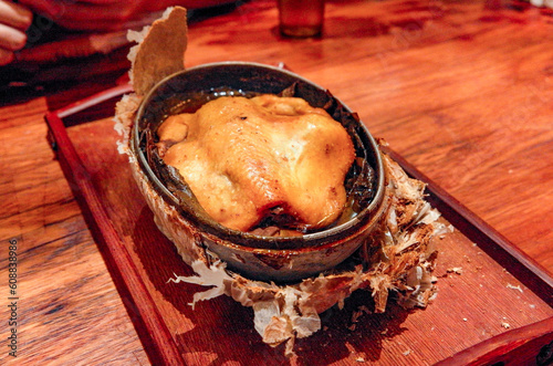 Whole chicken in clay shell and lotus leaves, beggar's chicken