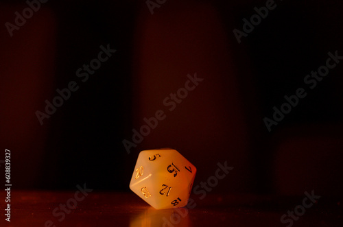 20 faced dice (icosahedron) on dark background
