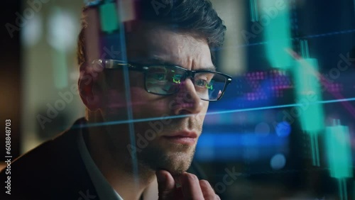 Closeup man analysing holographic statistics. Thoughtful stock trader planning