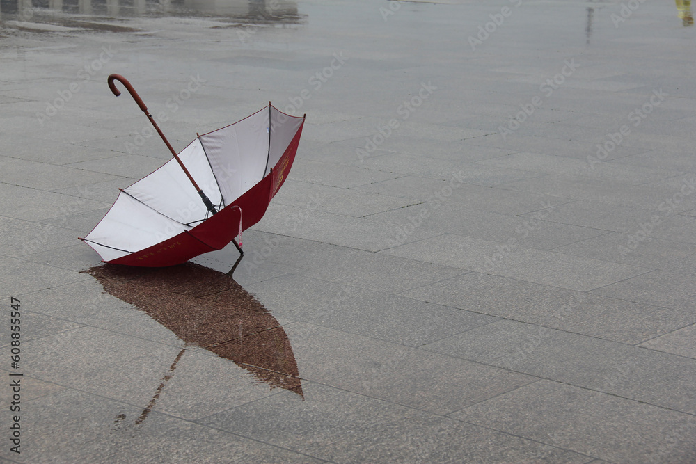 red and white umbrella in rainy time - obrazy, fototapety, plakaty 