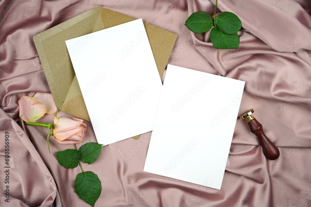 Double sided 5x7 invitation wedding program stationery suite mock-up styled with vintage wax seal, and pink rose, on a crushed dusty rose satin background.