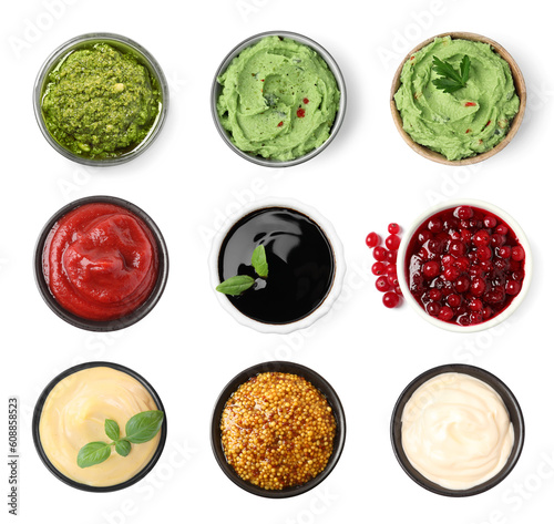 Set of guacamole and different sauces on white background, top view
