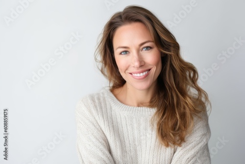 Portrait of a beautiful woman smiling at the camera over white background