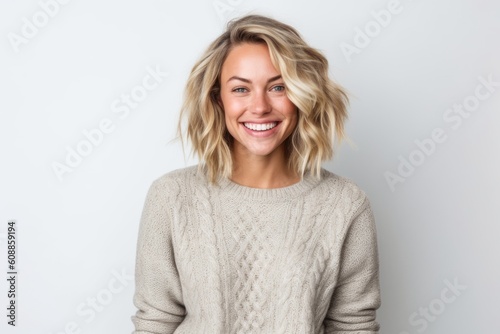 Portrait of a happy young woman with blonde hair on white background