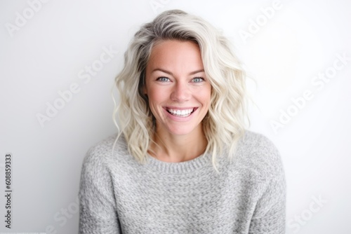 Portrait of a beautiful young woman smiling at the camera on white background