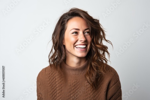 Close up portrait of a happy young woman smiling isolated on a white background © Robert MEYNER