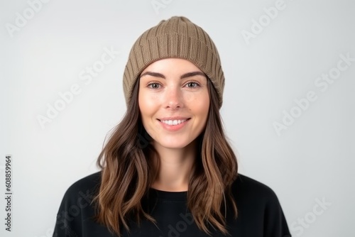 Portrait of a beautiful young woman in a hat on a white background