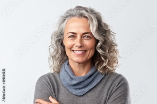 Portrait of a happy mature woman smiling at camera isolated on a white background © Anne-Marie Albrecht