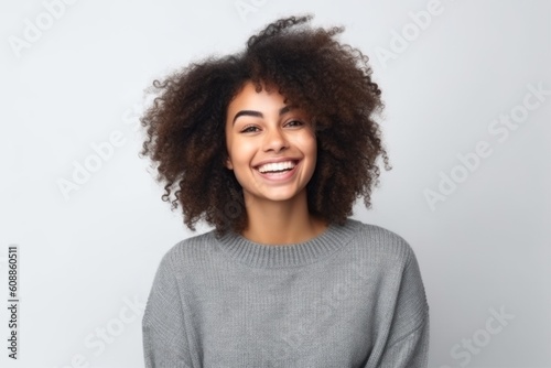 Portrait of a beautiful young african american woman laughing over white background