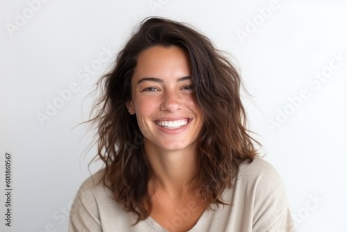Close up portrait of a smiling young woman with long brown hair on white background
