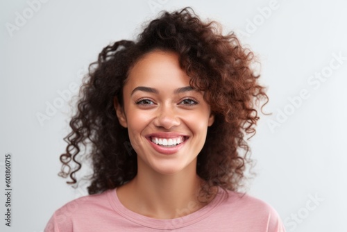 Portrait of a beautiful young african american woman smiling against white background