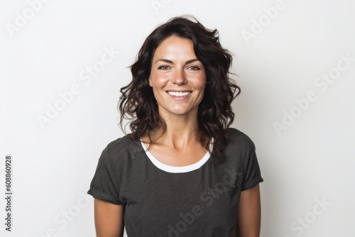 Portrait of smiling woman in grey t-shirt against white background