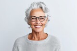Portrait of a smiling senior woman wearing eyeglasses isolated over white background