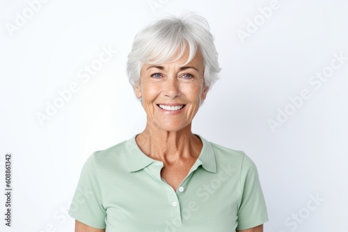 Portrait of a happy senior woman smiling at camera over white background