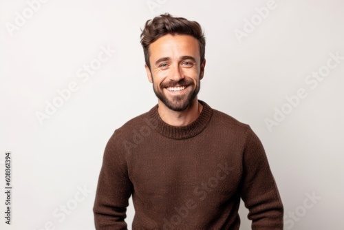 Portrait of a handsome young man smiling at the camera on a white background © Robert MEYNER