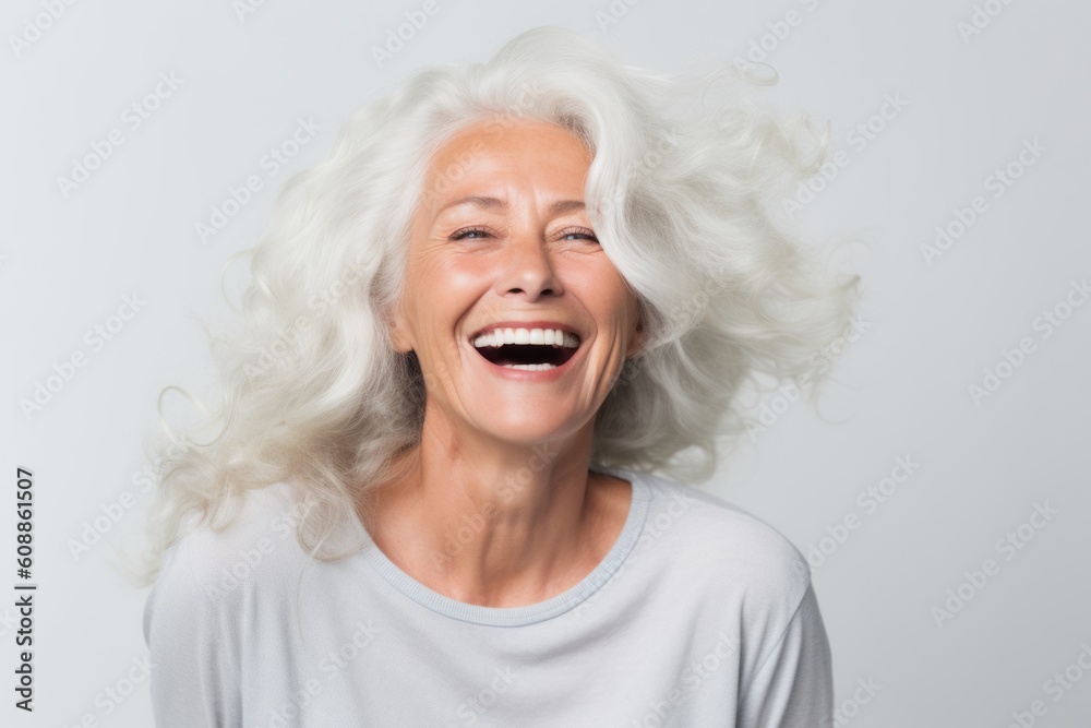 Portrait of a happy senior woman laughing at camera isolated on a white background Portrait of a happy senior woman laughing at camera isolated on a white background