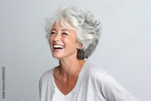 Lifestyle portrait photography of a satisfied woman in her 60s that is placed against a white background . Generative AI