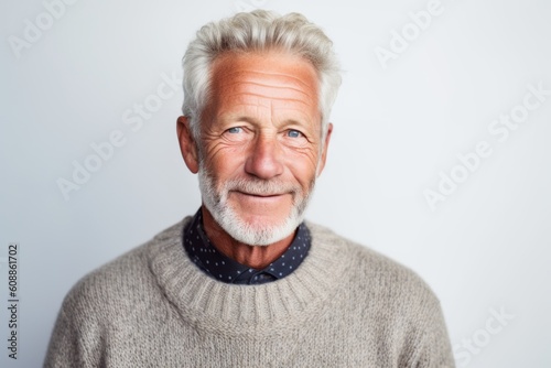 Portrait of happy senior man looking at camera over white background. © Eber Braun