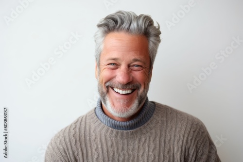 Portrait of a smiling middle-aged man with grey hair.