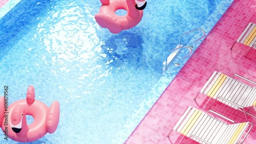 Flamingos float around the swimming pool photo