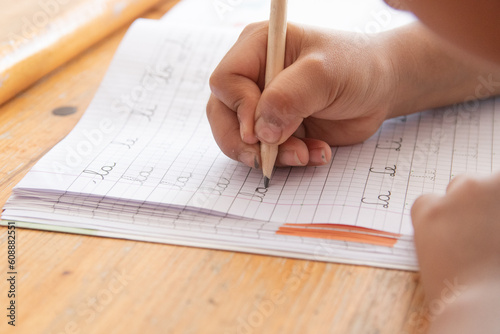 little boy doing calligraphy homework