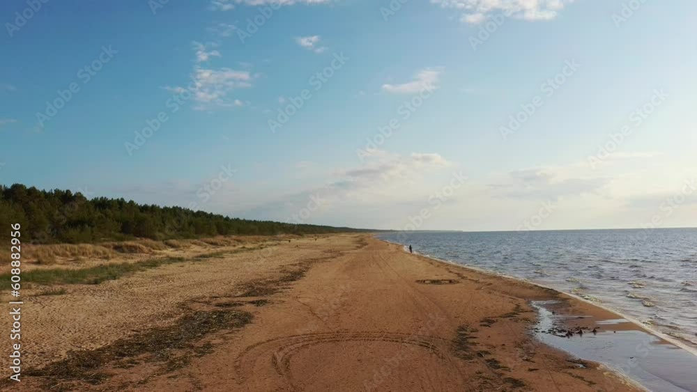 Aerial View of the Baltic Sea Coastline Garciems, Latvia. Empty Beach and Dunes in Summer Evening Before Sunset. Riga Gulf in Baltic Sea, Latvia. Aerial View of the Baltic Sea Coastline Garciems, Latvia. Empty Beach and Dunes in Summer Evening Before Sunset. Riga Gulf in Baltic Sea, Latvia.