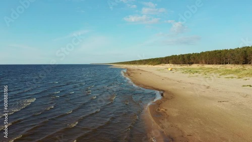 Aerial View of the Baltic Sea Coastline Garciems, Latvia. Empty Beach and Dunes in Summer Evening Before Sunset. Riga Gulf in Baltic Sea, Latvia. photo