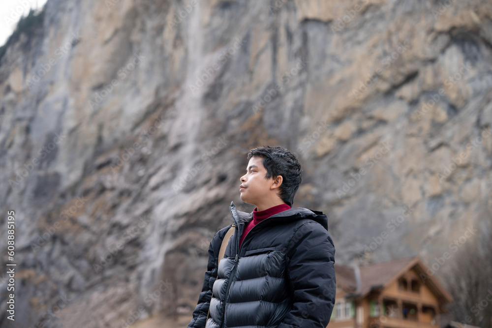 Man with Staubbach Falls Kirche nature during winter in Lauterbrunnen, Switzerland. Man with Staubbach Falls Kirche nature during winter in Lauterbrunnen, Switzerland.