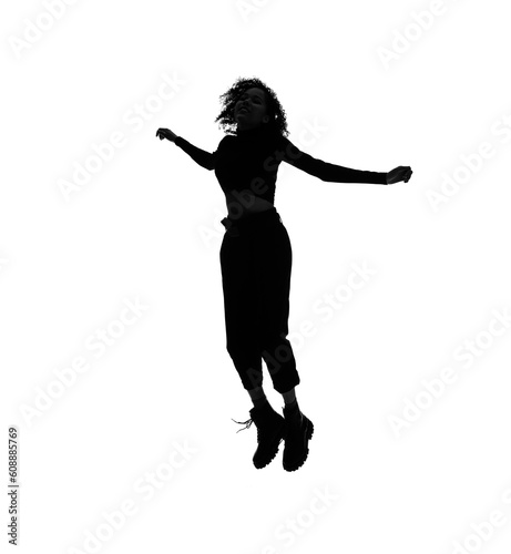 Profile silhouette of jumping black woman in studio shot.