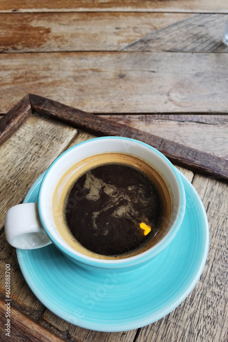 close up of a cup of coffee on wooden background 