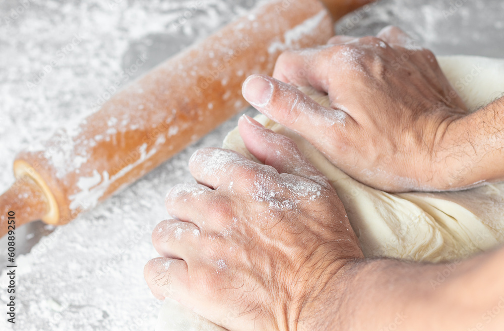Fototapeta premium man kneading dough