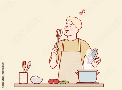 Funny guy singing song holding beater whisk microphone listening music in modern kitchen. Hand drawn style vector design illustrations.