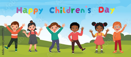 Cute kids waving hands posing at the park celebrating children day