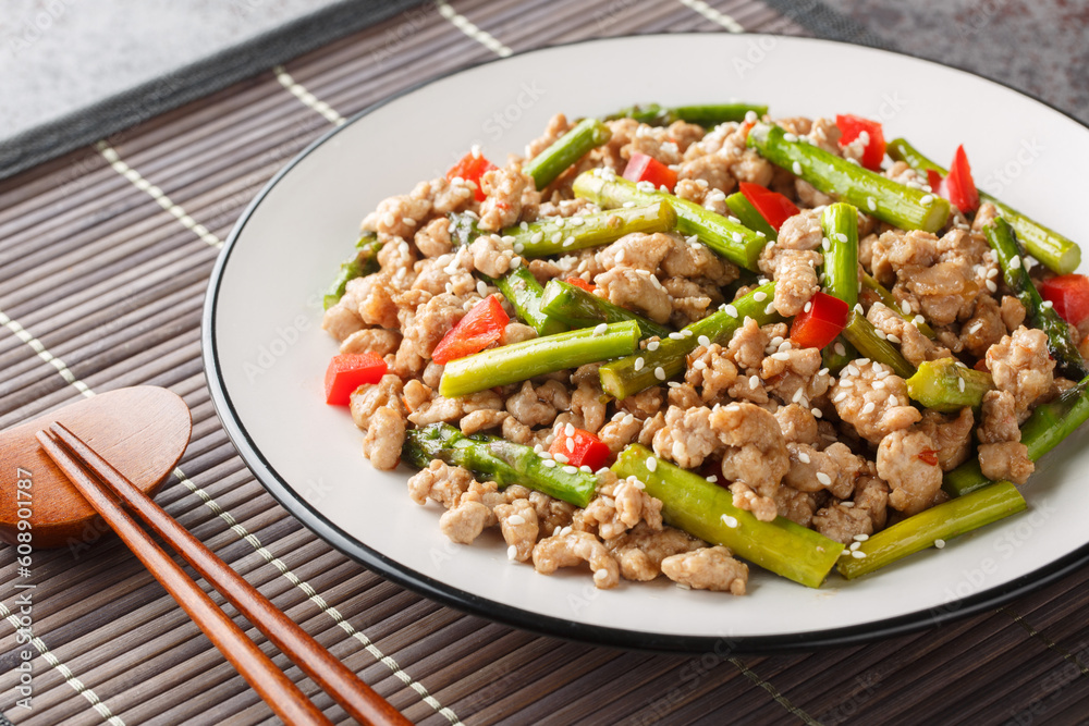 Pork Stir Fry with asparagus, garlic, chili and ginger closeup on the plate on the table. Horizontal Pork Stir Fry with asparagus, garlic, chili and ginger closeup on the plate on the table. Horizontal