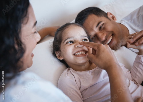 Love, smile and happy family in a bed laughing, bonding and playing in their home together. Face, playful and girl child with parents in a bedroom, having fun and enjoying a weekend in their house © Wesley J/peopleimages.com