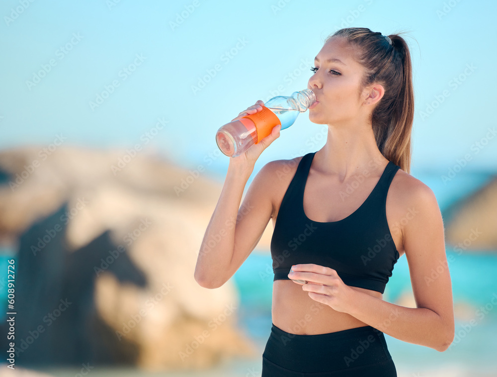 Athlete, woman and drinking water at the beach for fitness, exercise or training at the sea. Girl, person and drink from bottle in outdoor workout, yoga and calm break or rest in summer exercising Athlete, woman and drinking water at the beach for fitness, exercise or training at the sea. Girl, person and drink from bottle in outdoor workout, yoga and calm break or rest in summer exercising