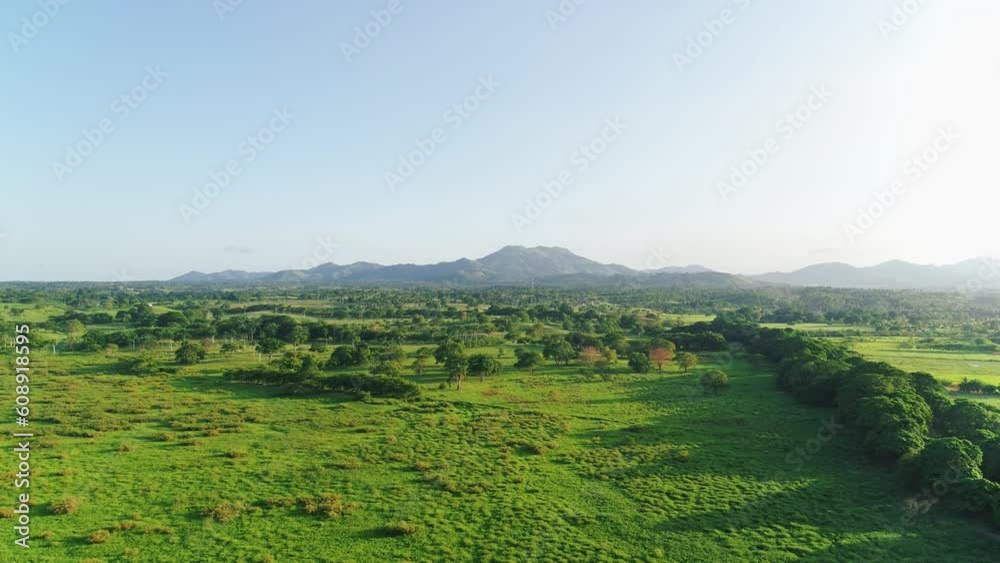 Top panoramic view of green fields and meadows in summer. Mountain range against a blue sky with white clouds. Summer mountain landscape in the Dominican Republic. Wild nature. Top panoramic view of green fields and meadows in summer. Mountain range against a blue sky with white clouds. Summer mountain landscape in the Dominican Republic. Wild nature.