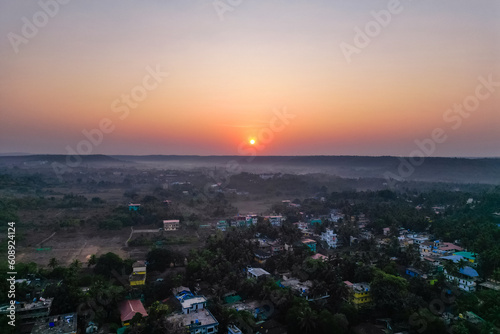 Aerial view of mountain peak and sea and sunset colorful sky from above from drone © yurakrasil