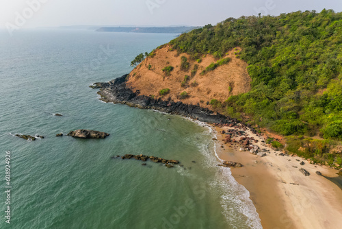 a flock of white small birds on the seashore on the sand view fron top drone in Goa