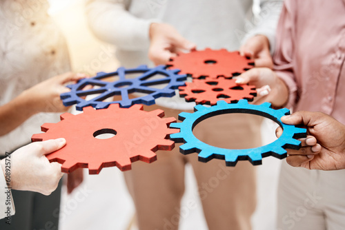 Professional, group and hands with gears for a collaboration in a meeting for support at a company. Teamwork, strategy and corporate employees with a partnership for a common goal for a project. photo