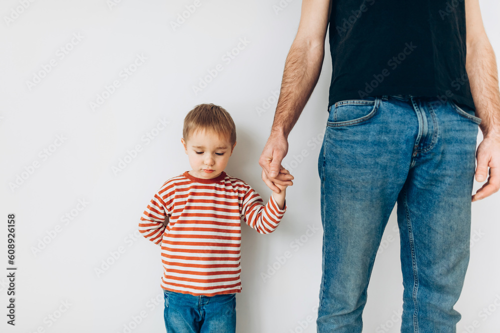 Caucasian little boy, hugging his father at home, isolated image, copy space. Family concept Caucasian little boy, hugging his father at home, isolated image, copy space. Family concept