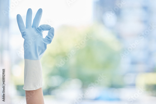 Hands, housekeeper and gloves with okay sign for cleaning, hygiene or home maintenance. Hand of person or cleaner with ok symbol, gesture and rubber glove for precise, perfect or bacteria free house