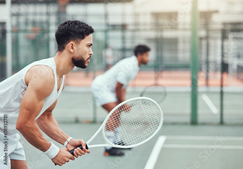 Man, tennis and team is ready on a court for game and exercise with wellness in india. Male athlete, together and racket competition with fitness for a challenge with a workout in the outdoor. photo